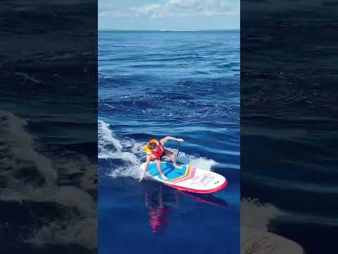 Paddleboards surfing behind our boat!